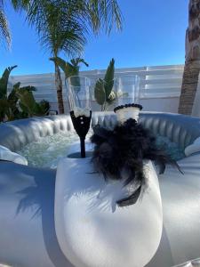 a glass of wine and two wine glasses in a hot tub at Villa Diana - 200 meters from Kapparis, Fireman's Beach in Paralimni