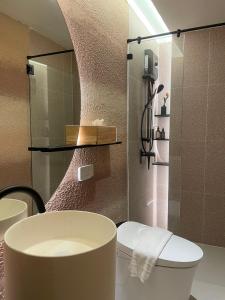 a bathroom with a toilet and a shower at Rema residence China town in Bangkok