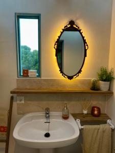 a bathroom with a sink and a mirror at Yurt in La Nucia met zwembad in La Nucía