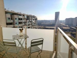 a table and chairs on a balcony with a view at Sui Generis penthouse with terraces in Milan