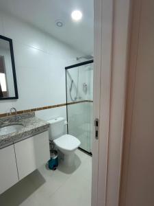 a bathroom with a toilet and a glass shower at Moderno e novo apt em frente o shopping Boulevard in Vila Velha