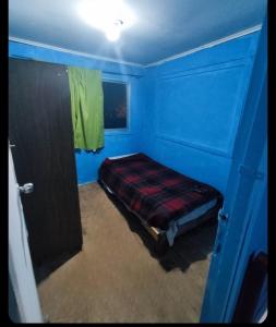 a room with a bed in a blue room at Casa atr@ in Viña del Mar