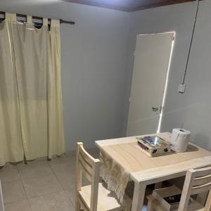 a room with a table and a mirror and a table and chair at Departamento Temporario amueblado in Corrientes