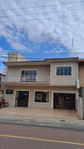 a building on the side of a street at Residencial da Leta in Garopaba