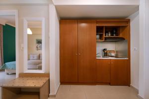 a living room with a wooden cabinet and a bench at Ktima Papaoikonomou 2 in Potos