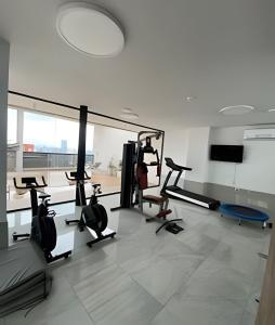 a gym with treadmills and ellipticals in a room at Tu Hogar de Lujo en el Corazón de Resistencia in Resistencia
