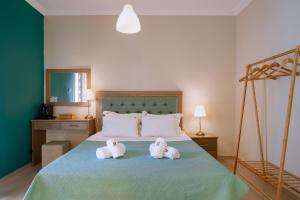 two stuffed animals are sitting on a bed at Ktima Papaoikonomou 2 in Potos +83 photos