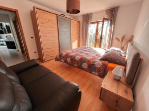a living room with a couch and a bed at Olive garden family apartment with private pool in Sežana