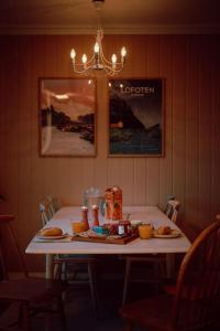 a white table with food on top of it at Reine Front View - Mountain & Seaview in Reine