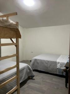 a bedroom with two bunk beds and a ladder at Haven´s Inn in Baños