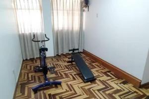 a room with a gym with a exercise bike on the floor at Kaypi Samay in Cusco