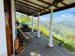 a porch of a house with a view of the mountains at Ella Black Bridge View Cottage Sri Lanka in Ella