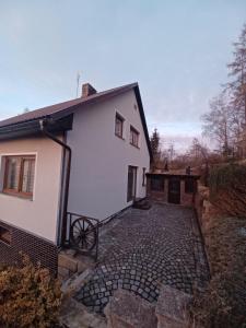 a white house with a cobblestone driveway at Sun House in Ostrov nad Oslavou
