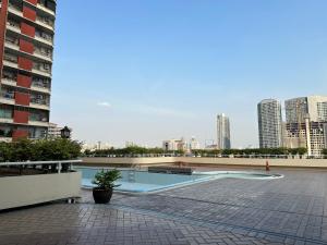 a swimming pool in the middle of a city at Country Complex Bangna in Bangkok