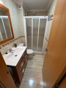 a bathroom with a shower and a sink and a toilet at Apartamento Pirámides in Caleta De Velez +16 photos