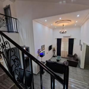 a living room with a couch and a table at Perriman Hotel in Kokrobite