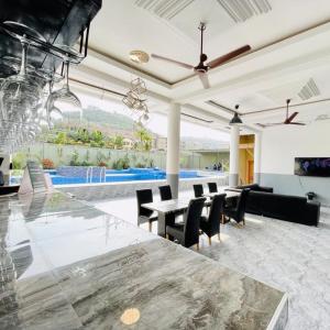 a living room with a large marble table and chairs at Perriman Hotel in Kokrobite