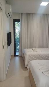 Cama o camas de una habitación en Apto Eco Resort Capivari - CTBA