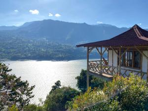 a gazebo on a hill overlooking a lake at Cabañas Ecoturismo Evy in Macanal