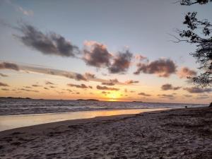 a sunset on a beach with the ocean at Colonia in Colonia del Sacramento