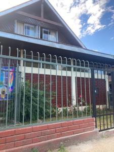 a metal fence in front of a building at Cygnus Hostel in Valdivia