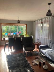 a living room with a table and a couch at Cygnus Hostel in Valdivia