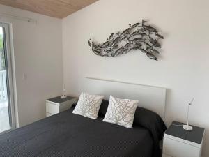 a bedroom with a black bed with two night stands and a window at Luxury Waterfront Villa 249C South Beach in Jolly Harbour