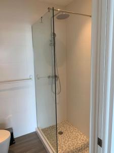 a shower with a glass door in a bathroom at Luxury Waterfront Villa 249C South Beach in Jolly Harbour