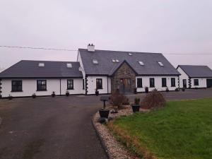 a large white building with a lot of windows at Connemara Ocean Escape in Galway
