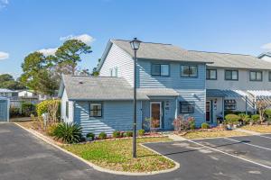 a blue house with a street light in front of it at Little River-condo-sleeps 10 By Hostique in Little River