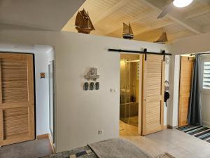 a bathroom with a walk in shower and a glass door at Tekila Beach, appt-condo au bord de mer a Saint-Martin SXM in Baie Nettle +31 photos