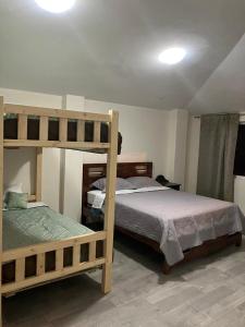 a bedroom with two bunk beds in a room at Haven´s Inn in Baños