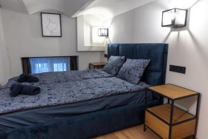 a bedroom with a large bed with a blue couch at Downtown Elegance in Budapest