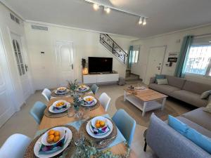 a living room with a table with plates of fruit on it at Casa Miro in Ciudad Quesada