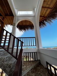 a balcony with stairs and a view of the ocean at Gamora Hotel Playa in Los Órganos