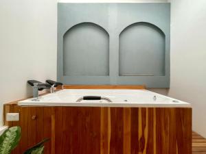 a bathroom with a sink with two arches above it at Lalinde by Wynwood House in Medellín