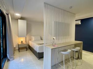 una camera con un letto e una scrivania con due sgabelli di Lalinde by Wynwood House a Medellín