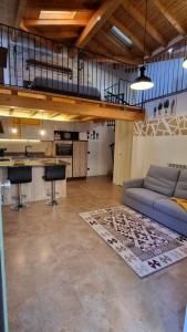 a living room with a couch and a kitchen at Casa del Cedro - Comfort e relax in Legnano