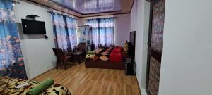 a living room with a bed and a dining room at Srinagar hotels and houseboats in Srinagar +17 photos