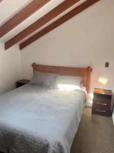 Ένα ή περισσότερα κρεβάτια σε δωμάτιο στο Cabañas Suecia