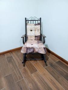 a chair sitting in a room with a wooden floor at Departamento ELSA. La Crucecita, Huatulco. in Santa Cruz Huatulco