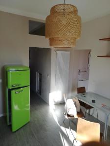 a living room with a green refrigerator and a table at Delizioso trilocale Lodi città in Lodi