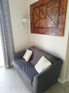 a couch with two pillows on it in a living room at Delizioso trilocale Lodi città in Lodi