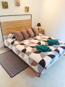 a bedroom with a large bed with a checkerboard at La Châteaude in Aubagne