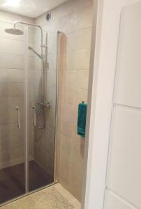 a shower with a glass door in a bathroom at La Châteaude in Aubagne
