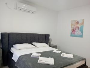 a bedroom with a bed with white towels on it at Apartmani Marija in Vrdnik +31 photos