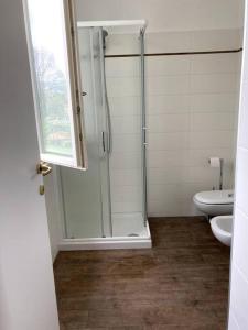 La salle de bains est pourvue d'une douche et de toilettes. dans l'établissement Cozy Escape in Bellagio, à Bellagio