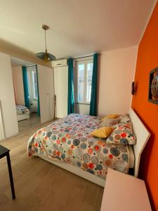 a bedroom with a bed with an orange wall at Zangàl al Vaticano - Metro Cornelia in Rome
