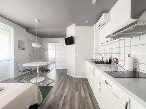 a kitchen with white cabinets and a table in it at Budget Inn in Valencia