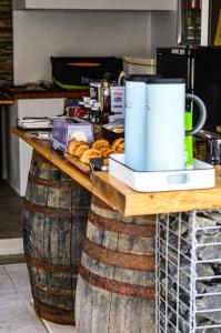 a counter with pastries on top of a large barrel at La Casa De Lylou location de bungalows in Lavos